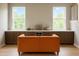 Stylish living area with built-in cabinets, a wine cooler, and a comfortable orange sofa at 69 Red Bluff St, Summerville, SC 29483