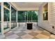 Cozy screened-in porch with checkered floors and views of the fenced-in yard at 69 Red Bluff St, Summerville, SC 29483