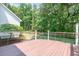 Spacious backyard deck with wood flooring, scenic backyard views, and elegant railing at 7053 Schooner St, Daniel Island, SC 29492