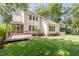 Spacious backyard with lush green grass, mature trees, and a screened in deck, perfect for outdoor entertaining at 7053 Schooner St, Daniel Island, SC 29492