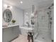 Luxurious bathroom featuring a soaking tub, glass shower, and stylish vanity with modern lighting at 7053 Schooner St, Daniel Island, SC 29492