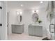 Serene bathroom with double marble vanities, mirrors, and a glass-enclosed shower at 7053 Schooner St, Daniel Island, SC 29492