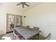 Inviting covered patio with a ceiling fan and wicker furniture for outdoor relaxation and dining at 7053 Schooner St, Daniel Island, SC 29492