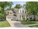 Charming two-story home with a two-car garage, landscaped yard, and inviting front porch at 7053 Schooner St, Daniel Island, SC 29492