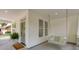 Inviting front porch featuring a swing, fern, and stylish green front door at 7053 Schooner St, Daniel Island, SC 29492