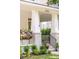Charming front porch with decorative plants, white columns, and the house number at 7053 Schooner St, Daniel Island, SC 29492
