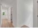 Upstairs hallway featuring hardwood floors, white trim, recessed lighting, and two doors at 7053 Schooner St, Daniel Island, SC 29492