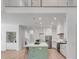 Open-concept kitchen with large island, modern cabinetry, and high ceilings, seamlessly connecting living spaces at 7053 Schooner St, Daniel Island, SC 29492