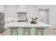Stylish kitchen island with marble countertop, seating, and light green cabinetry at 7053 Schooner St, Daniel Island, SC 29492