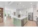 Spacious open-concept kitchen with large island, modern stainless appliances, hardwood floors, and access to dining area at 7053 Schooner St, Daniel Island, SC 29492
