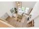 Sunlit living room with modern decor features hard wood floors, white sofa, and light fixture at 7053 Schooner St, Daniel Island, SC 29492
