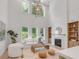 Inviting living room with fireplace, high ceilings, ample natural light, and comfortable white furniture at 7053 Schooner St, Daniel Island, SC 29492