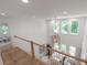 Open living area features hardwood floors, modern light fixture, and views of surrounding trees at 7053 Schooner St, Daniel Island, SC 29492