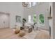 Bright, modern living room with soaring ceilings, plush white furniture, stylish decor, and large windows at 7053 Schooner St, Daniel Island, SC 29492