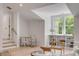 Bright living room featuring shiplap walls, built in shelves, light wood floors and modern furniture at 7053 Schooner St, Daniel Island, SC 29492