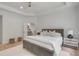 Bright main bedroom featuring a trey ceiling, light hardwood floors, and ensuite bathroom at 7053 Schooner St, Daniel Island, SC 29492
