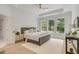Spacious main bedroom featuring light hardwood floors, a trey ceiling, and large windows at 7053 Schooner St, Daniel Island, SC 29492