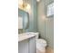 Stylish powder room with board and batten accent wall, elegant fixtures, and a modern sink at 7053 Schooner St, Daniel Island, SC 29492
