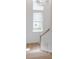 Bright staircase features wood treads, white risers, and large window for natural light at 7053 Schooner St, Daniel Island, SC 29492