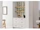 Stylish white storage nook with green triangle tile backdrop, open wood shelves and elegant decor at 7053 Schooner St, Daniel Island, SC 29492