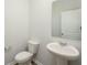 Cozy powder room with a pedestal sink, toilet, and mirror at 758 Meadowbrook Lane, Summerville, SC 29486