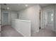 Light-filled hallway with neutral carpeting, leading to doorways that highlight a home's layout at 758 Meadowbrook Lane, Summerville, SC 29486