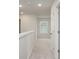 Upper hallway with plush carpeting, neutral walls, and natural light from the window in the bedroom at 758 Meadowbrook Lane, Summerville, SC 29486