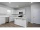Bright kitchen features white cabinets, stainless steel appliances, quartz counters, and a central island with seating at 758 Meadowbrook Lane, Summerville, SC 29486