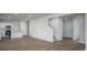 Open-concept living area with wood-look flooring, white walls, and a seamless transition to the kitchen and staircase at 758 Meadowbrook Lane, Summerville, SC 29486