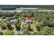 Aerial view of a lovely home surrounded by trees and near a lake at 7878 Gull Bay Dr, Awendaw, SC 29429