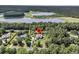 Aerial view of a lovely home and neighborhood surrounded by trees and a lake at 7878 Gull Bay Dr, Awendaw, SC 29429