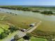 Scenic aerial view showcasing a community dock and waterfront living at 7878 Gull Bay Dr, Awendaw, SC 29429