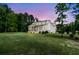 Expansive backyard featuring lush greenery and a charming covered patio at 7878 Gull Bay Dr, Awendaw, SC 29429