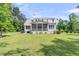 A large, screened-in porch overlooks the grass backyard at 7878 Gull Bay Dr, Awendaw, SC 29429