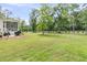 This large backyard has a screened-in porch, grill, and privacy fence at 7878 Gull Bay Dr, Awendaw, SC 29429