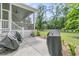 Spacious backyard with a covered patio, grills, and a lush green lawn at 7878 Gull Bay Dr, Awendaw, SC 29429