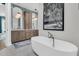 Bathroom featuring a modern tub, stylish mirrors, and contemporary fixtures at 7878 Gull Bay Dr, Awendaw, SC 29429