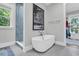 Bathroom featuring a modern tub, stylish shower and a large palm tree print at 7878 Gull Bay Dr, Awendaw, SC 29429