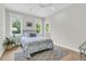 Cozy bedroom with large windows, a bed with blue bedding, and a gray rug at 7878 Gull Bay Dr, Awendaw, SC 29429