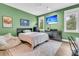 Inviting bedroom with green walls, comfortable furniture, and a mounted television for entertainment at 7878 Gull Bay Dr, Awendaw, SC 29429