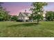 Twilight view of the rear of the home and screened-in porch at 7878 Gull Bay Dr, Awendaw, SC 29429
