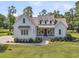 Beautiful two-story home with inviting front porch and manicured lawn at 7878 Gull Bay Dr, Awendaw, SC 29429