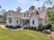 Charming two-story home with landscaped yard and a welcoming front porch at 7878 Gull Bay Dr, Awendaw, SC 29429