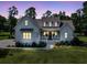 Home with inviting front porch, lit for the evening at 7878 Gull Bay Dr, Awendaw, SC 29429