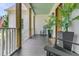 Cozy front porch with rocking chairs, potted plants, and wooden columns at 7878 Gull Bay Dr, Awendaw, SC 29429