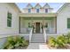 Inviting front porch with rocking chairs and beautiful landscaping at 7878 Gull Bay Dr, Awendaw, SC 29429