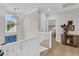 Open hallway with light hardwood floors, white railings, and views of a beautifully decorated space at 7878 Gull Bay Dr, Awendaw, SC 29429