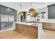 Modern kitchen with stainless steel appliances, quartz countertops, and a spacious island at 7878 Gull Bay Dr, Awendaw, SC 29429