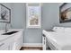 Well-lit laundry room featuring a sink, washer, dryer, and beach-themed decor at 7878 Gull Bay Dr, Awendaw, SC 29429