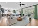 Bright living room with a ceiling fan, stylish furniture, and access to an outdoor patio at 7878 Gull Bay Dr, Awendaw, SC 29429